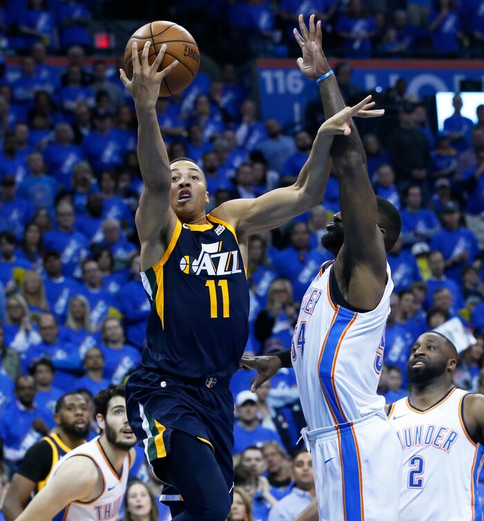 Utah Jazz guard Dante Exum (11) shoots in front of Oklahoma City Thunder forward Patrick Patterson, right, in the second half of Game 1 of an NBA basketball first-round playoff series in Oklahoma City, Sunday, April 15, 2018. (AP Photo/Sue Ogrocki)