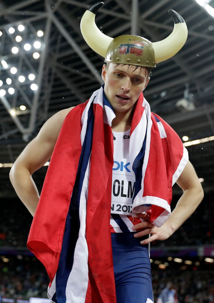 Norway's Karsten Warholm wears a viking helmet celebrates after winning the gold medal in the men's 400-meter hurdles during the World Athletics Championships in London Wednesday, Aug. 9, 2017. (AP Photo/Matthias Schrader)