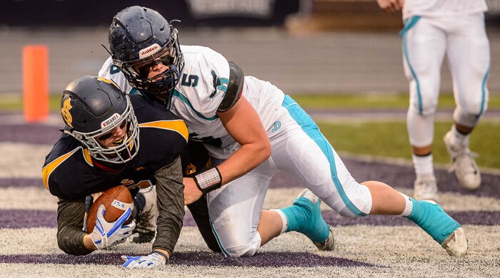 (Trent Nelson | The Salt Lake Tribune)  Summit Academy's Hunter Housel strips the ball from Juan Diego's Peyton Seim, resulting in a turnover. Summit Academy faces Juan Diego High School in a class 3A state semifinal football game at Weber State University's Stewart Stadium, Saturday November 4, 2017.