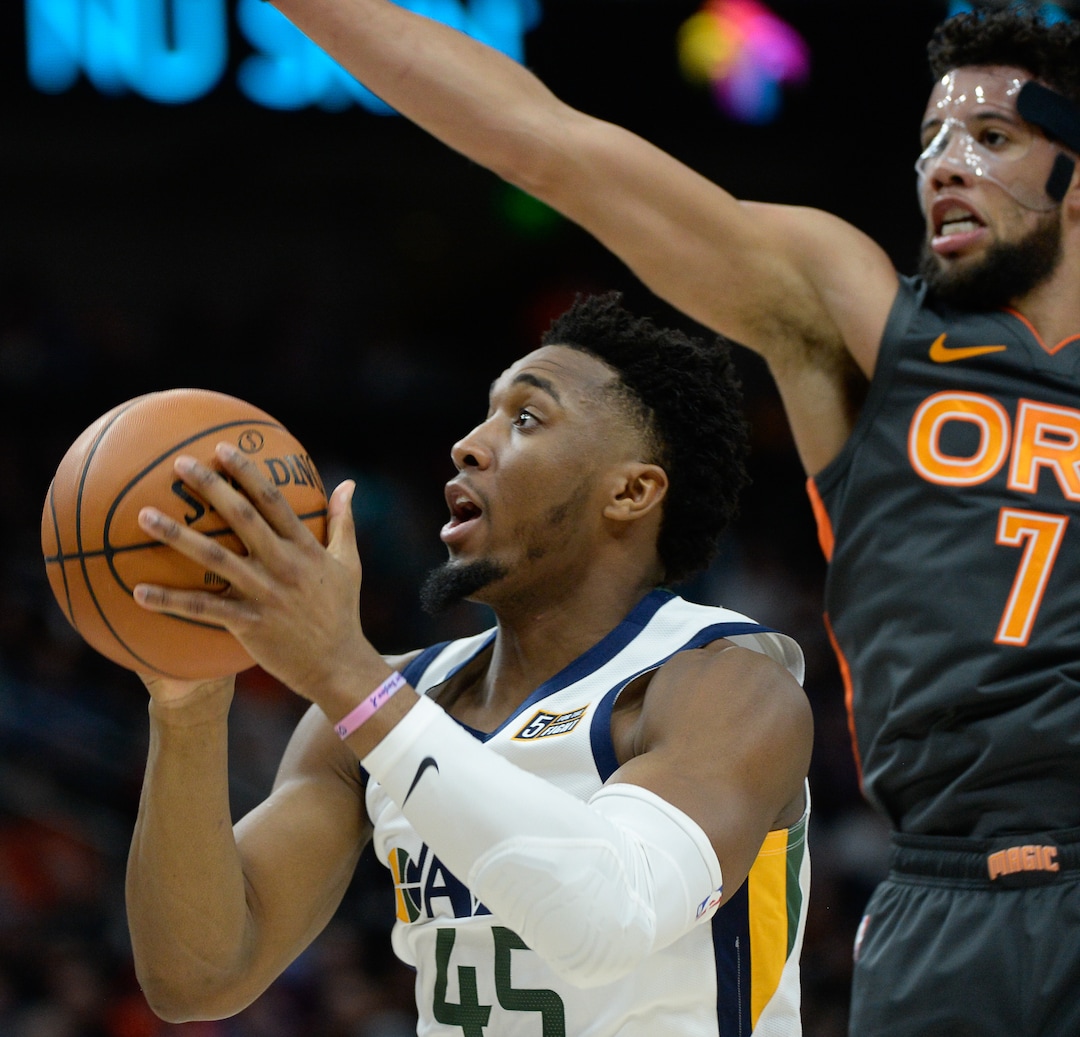 (Francisco Kjolseth  |  The Salt Lake Tribune) Utah Jazz guard Donovan Mitchell (45) pushes past Orlando Magic guard Michael Carter-Williams (7) as the Utah Jazz host the Orlando Magic in their NBA basketball game at Vivint Smart Home Arena in Salt Lake City on Tuesday. Dec. 17, 2019.
