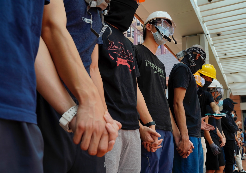 (Vincent Yu | AP file photo) Students from Hong Kong University chains their hands outside schools in Hong Kong, Monday, Sept. 9, 2019. The silent protest comes as the Hong Kong government condemned the "illegal behavior of radical protesters" and warned the U.S. to stay out of its affairs.
