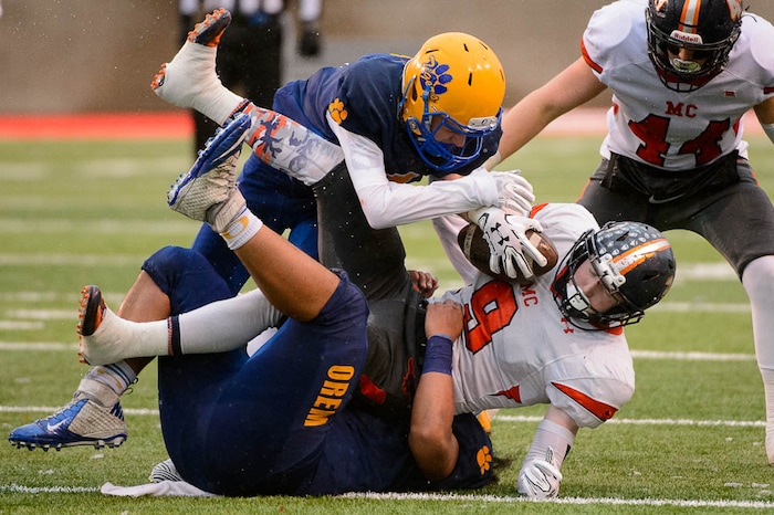 (Trent Nelson | The Salt Lake Tribune)  Mountain Crest's Joshua Powell (9) is tackled as Orem faces Mountain Crest in the Class 4A High School State Football Championship game in Salt Lake City, Friday November 17, 2017.