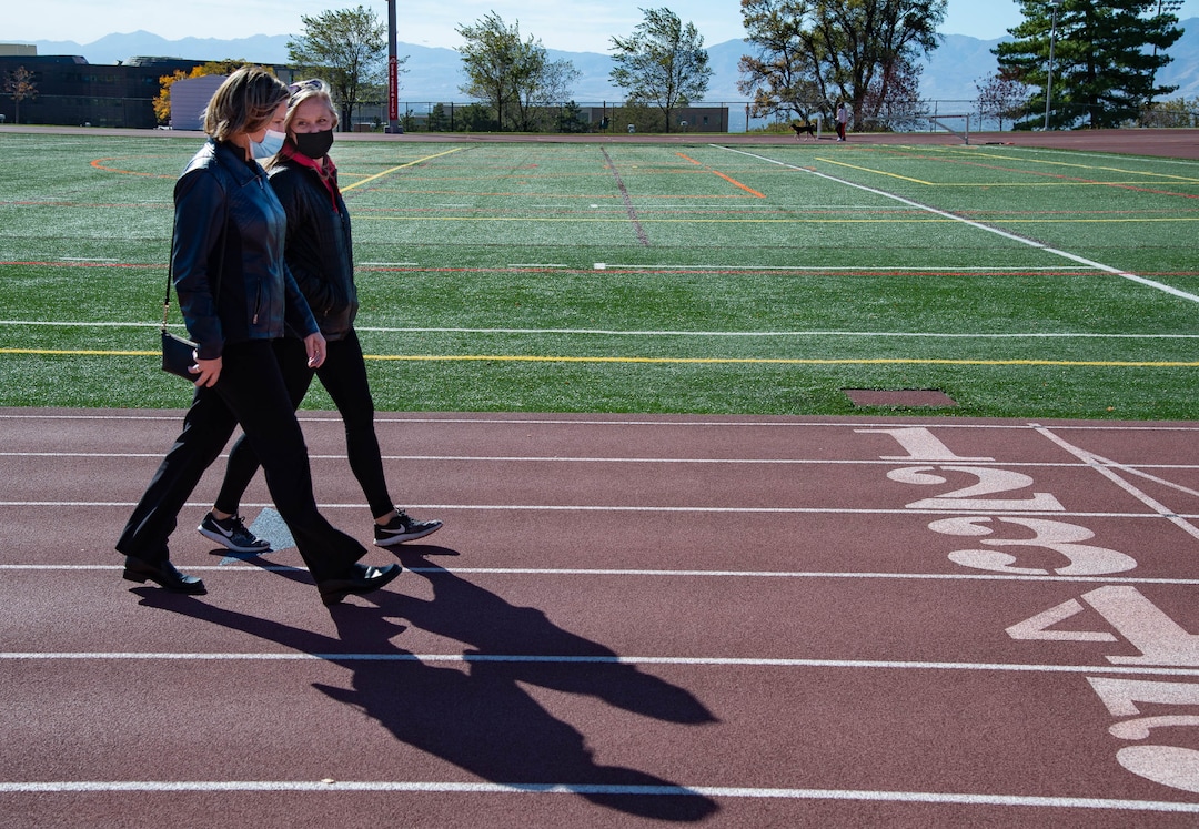 (Francisco Kjolseth  |  The Salt Lake Tribune) Jill McCluskey, left, is joined by Jenn Oxborrow, former director of the Utah Domestic Violence Coalition as they walk the track where Jill’s daughter Lauren McCluskey used to compete, during a memorial walk on the two-year anniversary of her murder on Thursday, Oct. 22, 2020.