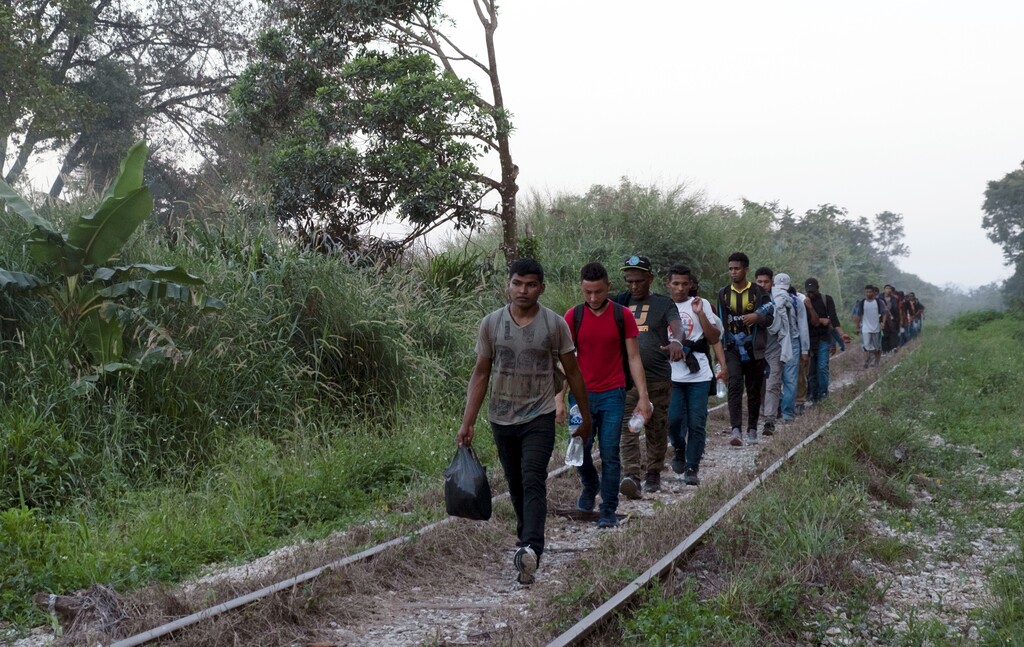 Migrants walk on train tracks on their journey from Central America to the U.S. border., in Palenque, Chiapas state, Mexico, Wednesday, Feb. 10, 2021. President Joe Biden's administration has taken steps toward rolling back some of the harshest policies of ex-President Donald Trump, but a policy remains allowing U.S. border officials to immediately send back almost anyone due to the new coronavirus pandemic. (AP Photo/Isabel Mateos)
