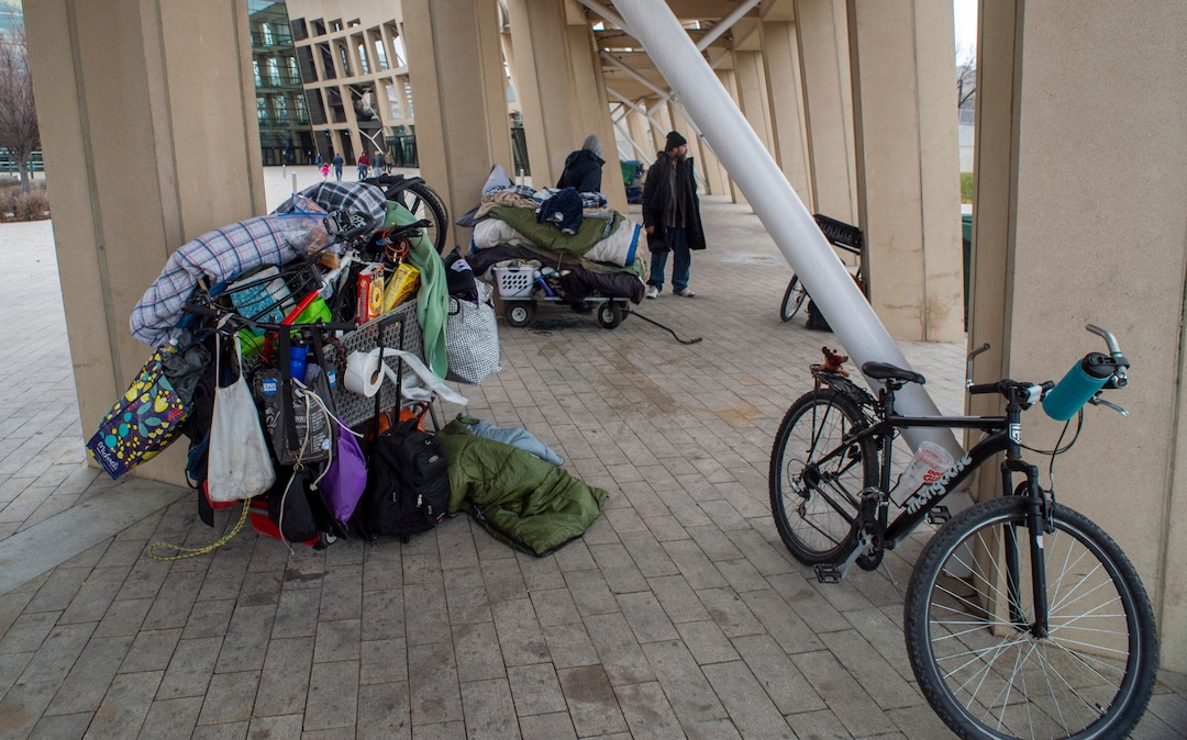 (Rick Egan | The Salt Lake Tribune) People are forced to pack up their belongings in carts and wagons near the Salt Lake City Library, Monday, Dec. 23, 2019.