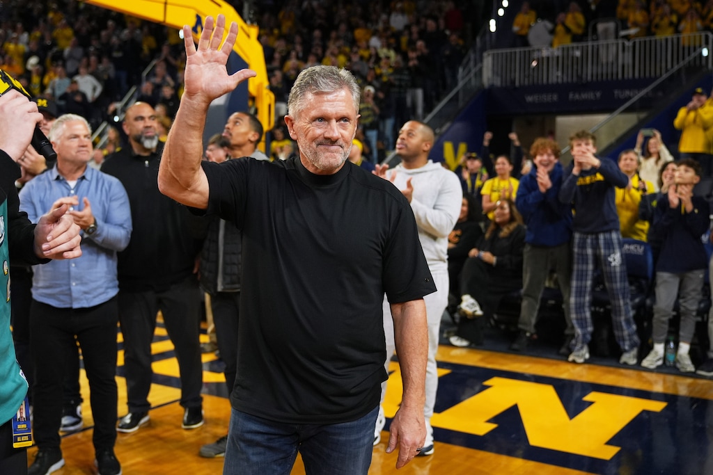 (Ryan Sun | AP) Michigan Football head coach Kyle Whittingham greets the crowd during the first half of the Wolverines' basketball game against Southern California, on Friday, Jan. 2, 2026, in Ann Arbor, Mich.