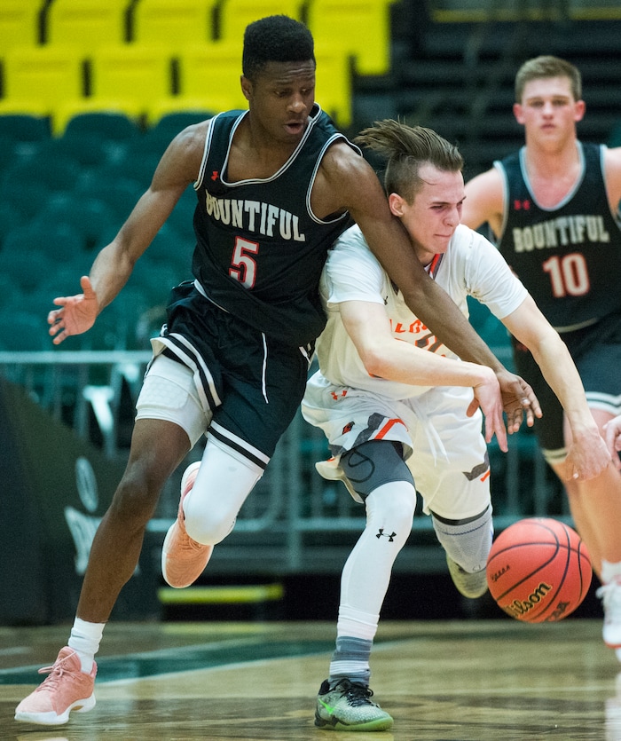 (Rick Egan  |  The Salt Lake Tribune)   Bountiful Braves Jaxon Wood (5) steals the ball from Skyridge Falcons Joe White (32), in 5A basketball playoff action between the Bountiful Braves and Skyridge Falcons, at the UCCU Center in Orem, Monday, Feb. 26, 2018.