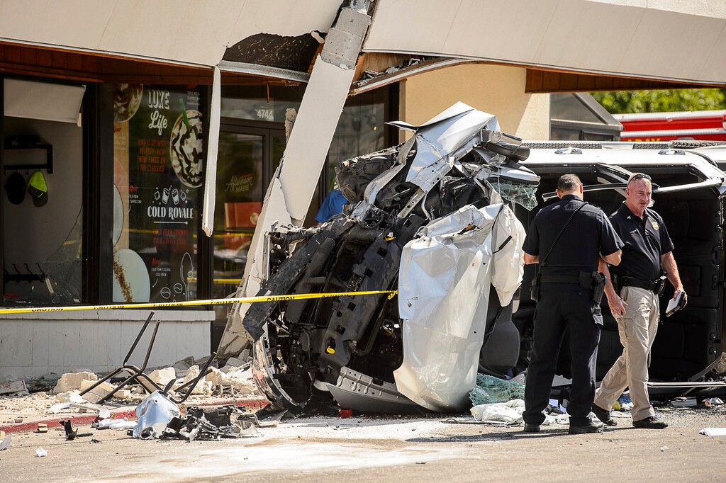 Authorities work at the scene where a pickup truck drove into a Starbucks parking lot and onto an outdoor patio, Friday June 8, 2018, at a Salt Lake City suburban shopping center in Millcreek, Utah. One person is dead and several others injured. (Trent Nelson/The Salt Lake Tribune via AP)