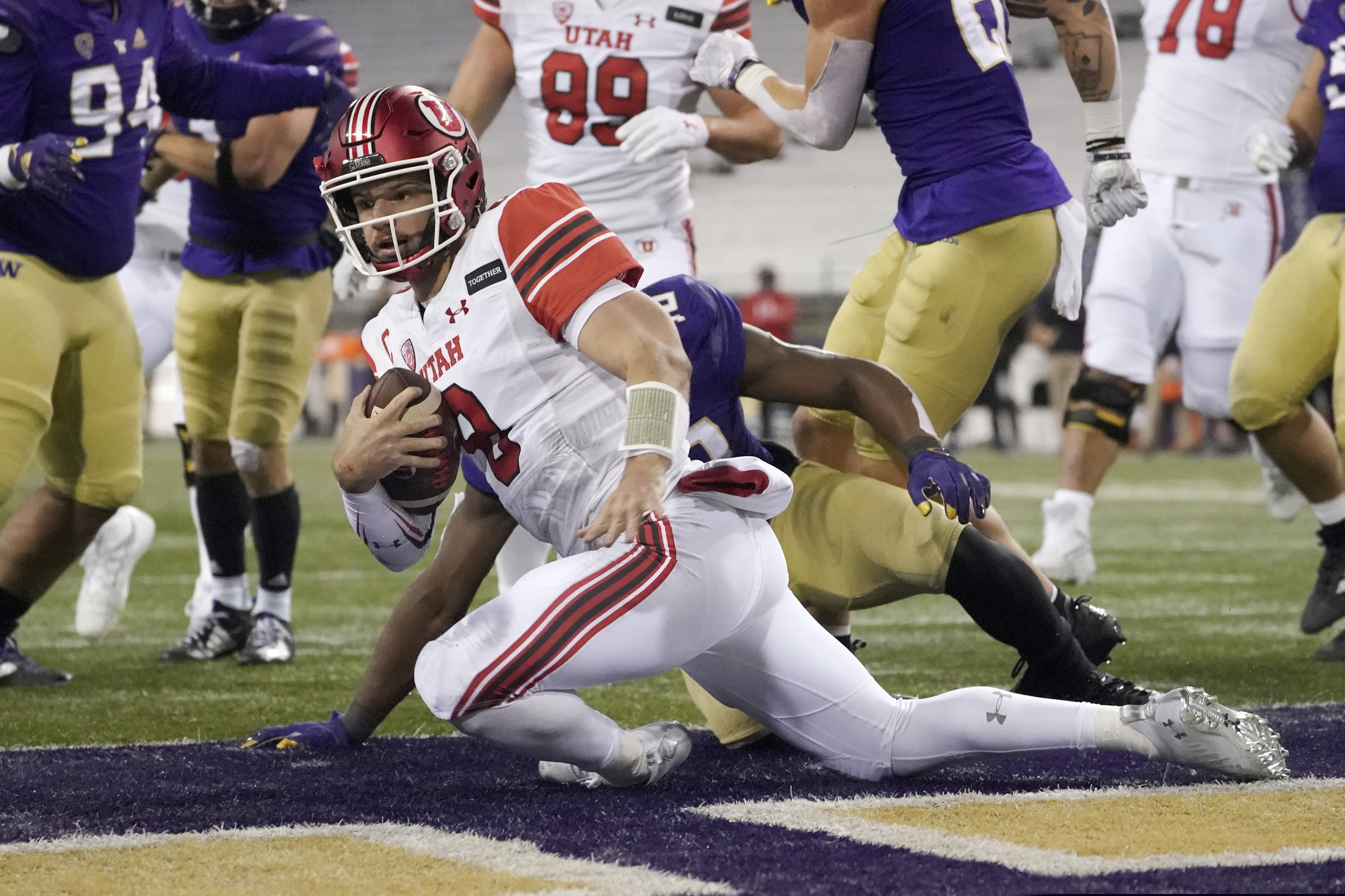 (Ted S. Warren | The Associated Press) Utah quarterback Jake Bentley keeps the ball for a touchdown against Washington during the first half of an NCAA college football game Saturday, Nov. 28, 2020, in Seattle.