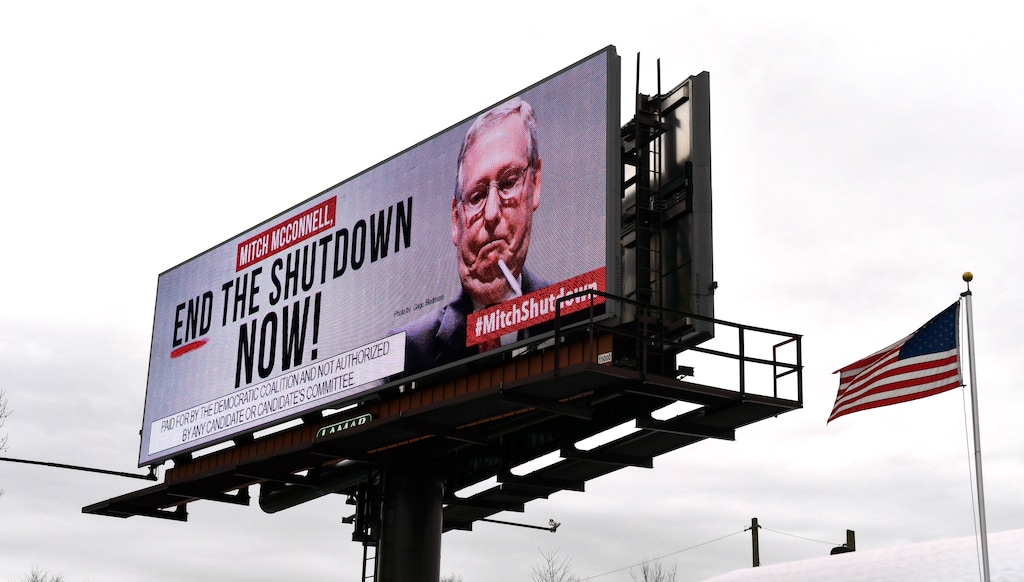 An electronic billboard, sponsored by the Democratic Coalition, shown Saturday, Jan. 12, 2019 in Nicholasville, Ky. McConnell, who is up for re-election in 2020 in a state where Trump tends to be more popular than he is, sees no other choice than to stand back and let the president who took the country into the shutdown decide how he wants to get out of it. (AP Photo/Timothy D. Easley)