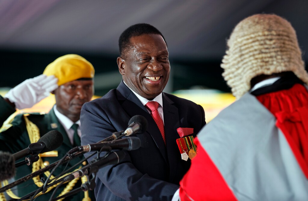 Emmerson Mnangagwa, center, is sworn in as President at the presidential inauguration ceremony in the capital Harare, Zimbabwe Friday, Nov. 24, 2017. Mnangagwa is being sworn in as Zimbabwe's president after Robert Mugabe resigned on Tuesday, ending his 37-year rule. (AP Photo/Ben Curtis)