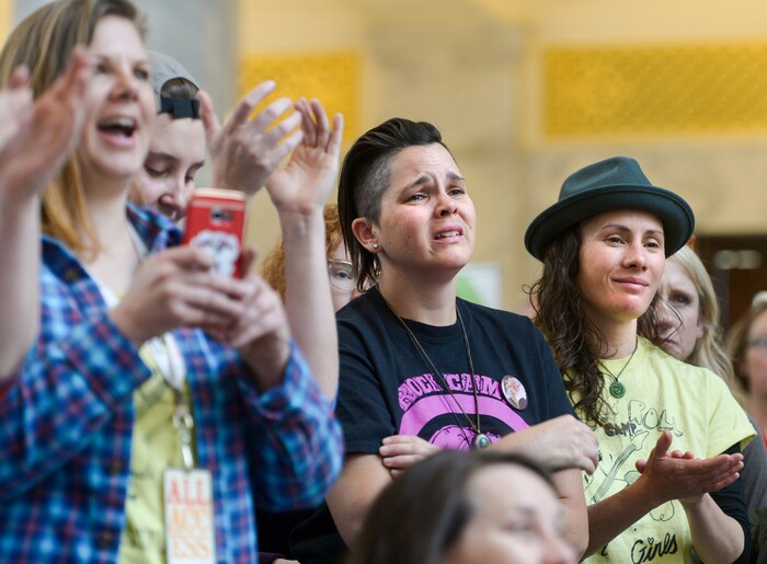 (Leah Hogsten | The Salt Lake Tribune) Talia Keys, center, gets teary-eyed while listening to speakers with her girlfriend Mehlan Atkinson, right, at Amplifying WomenÕs Voices rally to celebrate International WomenÕs Day at the Utah State Capitol Rotunda, hosted by KRCL, Thursday, March 8, 2018.