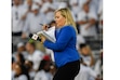(Barry Reeger | AP) ESPN reporter Holly Rowe looks over her notes before an NCAA college football game against Auburn in State College, Pa., on Saturday, Sept.18, 2021.