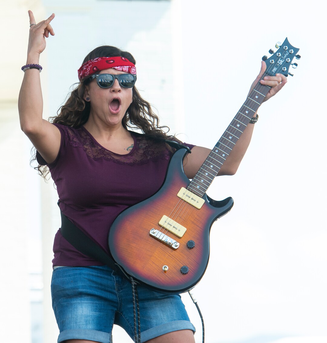 (Rick Egan  |  The Salt Lake Tribune)    Autumn Butler, from Ogden, was called from the crowd and given a guitar to be a rock star for a day, during the SongBlast Dueling Guitars show at the Utah State Fair Monday, Sept. 9, 2019.