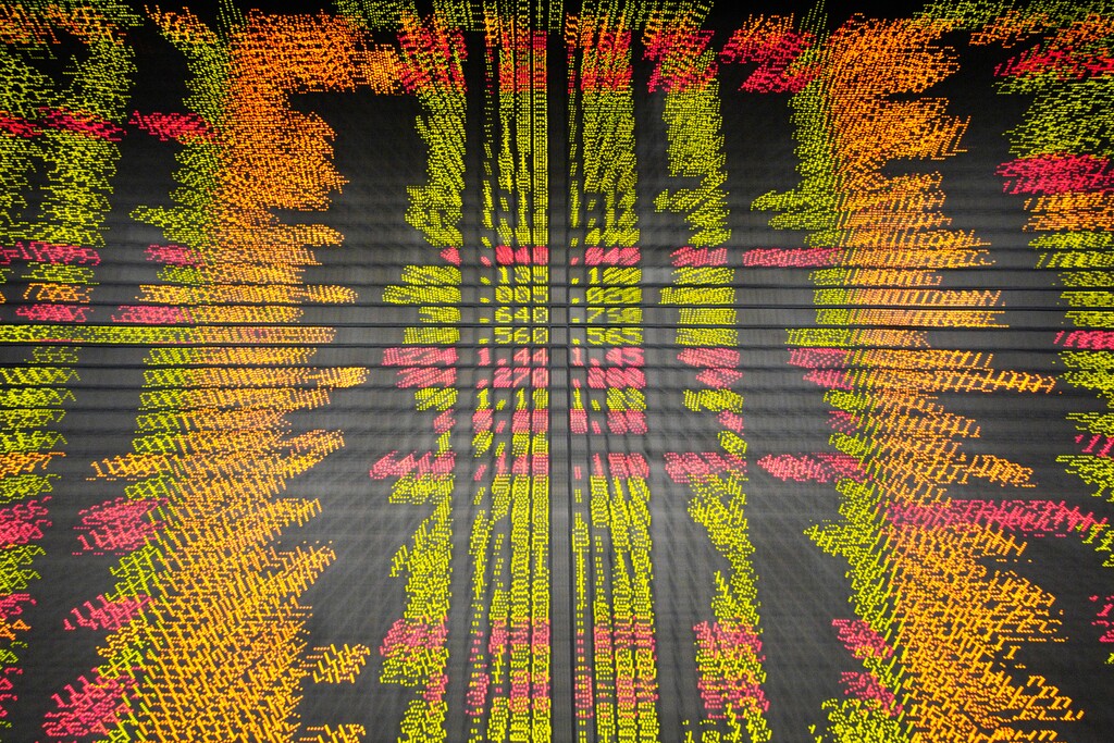An electronic board displays stock prices at a private stock market gallery in Kuala Lumpur, Malaysia, Friday, Nov. 30, 2018. Share prices were mixed Friday in Asia ahead of the planned meeting by Presidents Donald Trump of the U.S. and Xi Jinping of China at the Group of 20 summit this weekend. (AP Photo/Yam G-Jun)