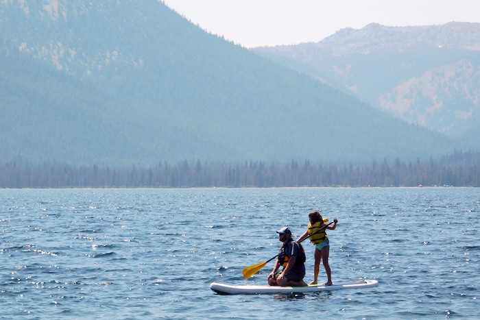 Erik Yost and his daughter Elizabeth float over Alturas Lake on a stand-up paddle board August 20, 2017 near Stanley, Idaho.  (Erin Alberty  |  The Salt Lake Tribune)
