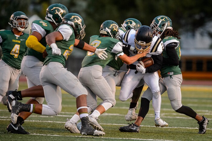 (Trent Nelson | The Salt Lake Tribune) Lone Peak's Brigham Trowbridge is stopped by a crowd of Kearns defenders as Kearns hosts Lone Peak, high school football, Thursday September 14, 2017.
