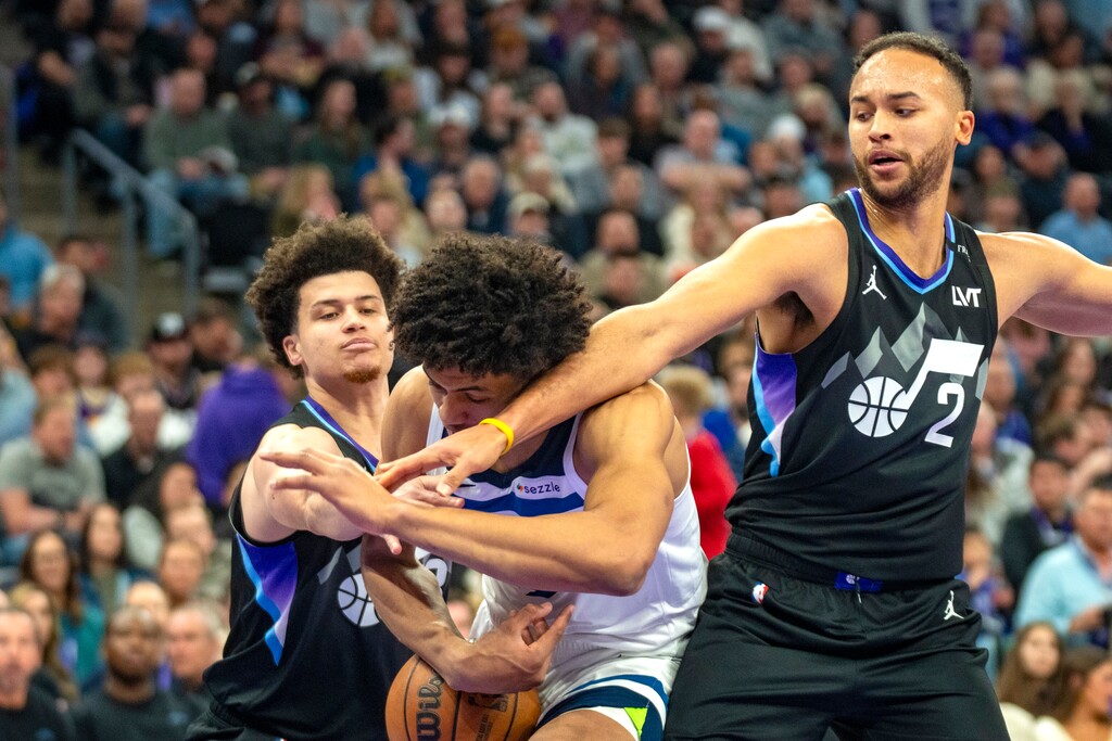 (Rick Egan | The Salt Lake Tribune) Minnesota Timberwolves forward Joan Beringer (19) goes for a shot as Utah Jazz forward Kyle Anderson (2) and guard Walter Clayton Jr. defend.
