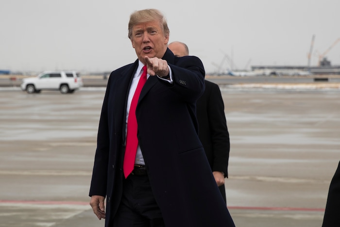 President Donald Trump points at supporters after arriving at Salt Lake City International Airport, Monday, Dec. 4, 2017, in Salt Lake City. (AP Photo/Evan Vucci)
