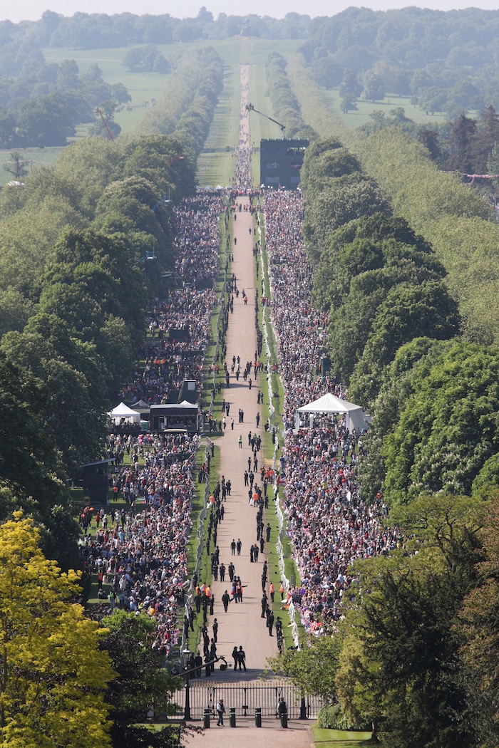 Spectators gather along the Long Walk ahead of the wedding of Prince Harry and Meghan Markle at Windsor castle in Windsor near London, England, Saturday May 19, 2018.  (Yui Mok/PA via AP)
