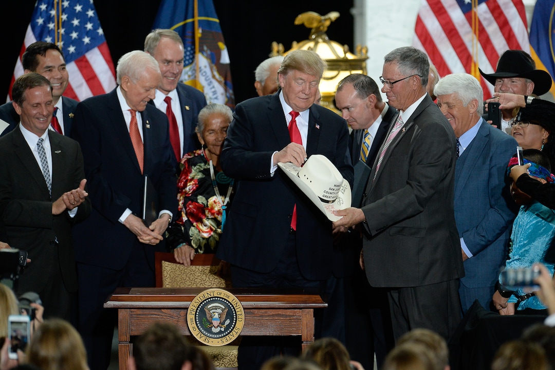 (Francisco Kjolseth  |  The Salt Lake Tribune)  Bruce Adams, right, Chairman of the San Juan County Commission has his hat signed by U.S. President Donald Trump at the Utah Capitol on Monday, Dec. 4, 2017, following Trump's signing of two presidential proclamations to shrink Bears Ears and Grand Staircase-Escalante national monuments.