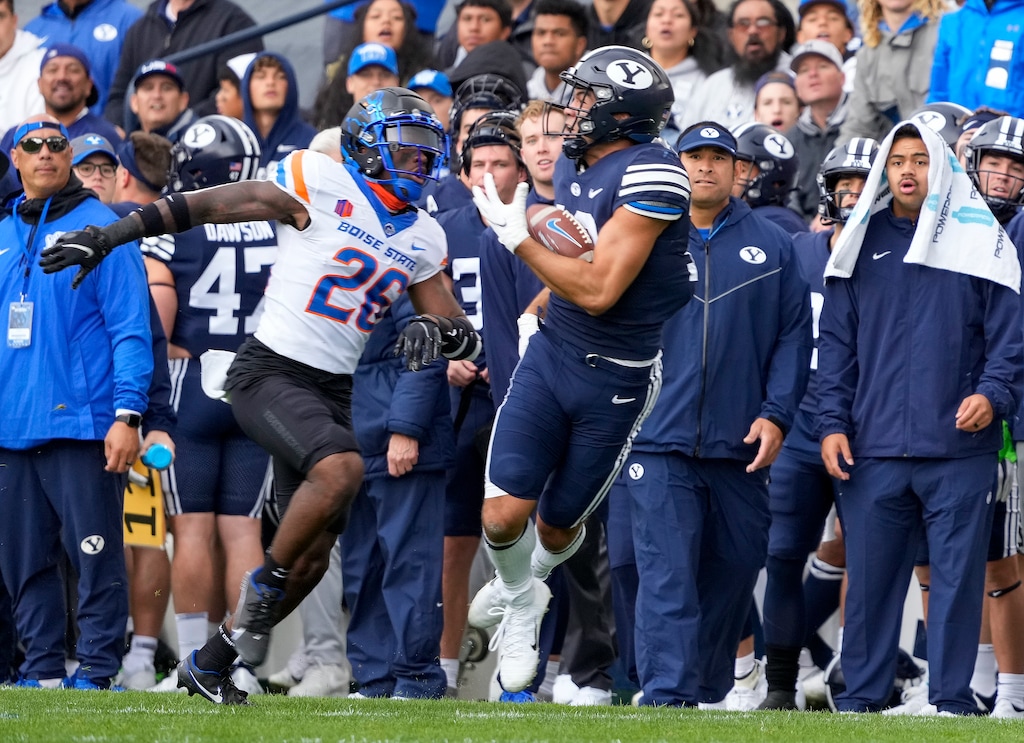 (Leah Hogsten | The Salt Lake Tribune) Brigham Young Cougars wide receiver Puka Nacua (12) pulls in the catch with Boise State Broncos cornerback Caleb Biggers (26) as No. 10 Brigham Young University hosts Boise State at LaVell Edwards Stadium, Oct. 9, 2021. 