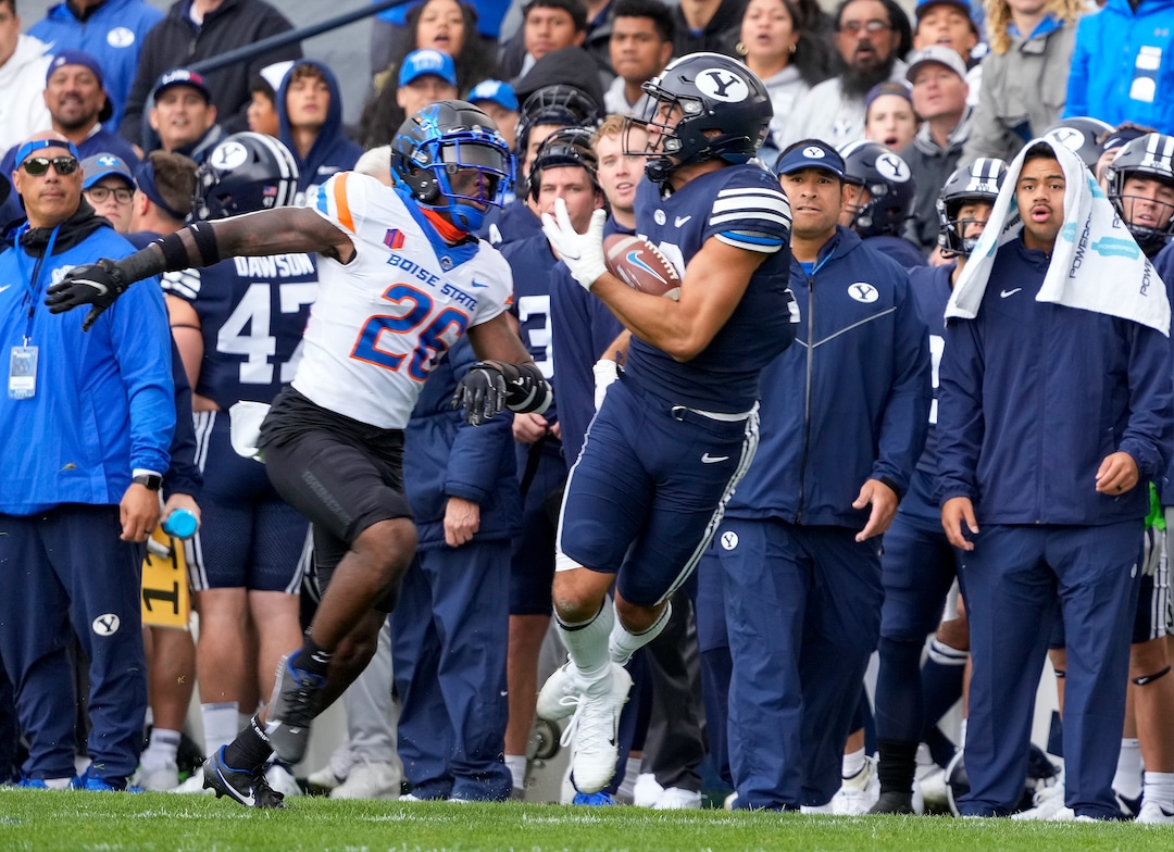 (Leah Hogsten | The Salt Lake Tribune) Brigham Young Cougars wide receiver Puka Nacua (12) pulls in the catch with Boise State Broncos cornerback Caleb Biggers (26) as No. 10 Brigham Young University hosts Boise State at LaVell Edwards Stadium, Oct. 9, 2021.