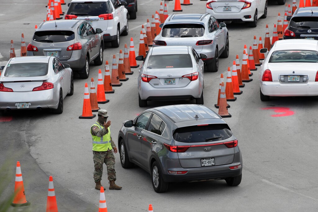 (Wilfredo Lee | AP) A National Guardsman directs traffic at a COVID-19 testing site outside Hard Rock Stadium, Wednesday, July 8, 2020, in Miami Gardens, Fla. Florida is one of the nation's hot spots for coronavirus.