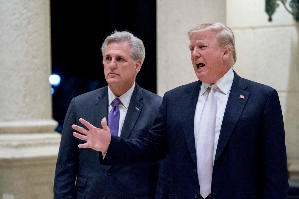 President Donald Trump, right, accompanied by House Majority Leader Kevin McCarthy, R-Calif., speaks to members of the media as they arrive for a dinner at Trump International Golf Club in West Palm Beach, Fla., Sunday, Jan. 14, 2018. (AP Photo/Andrew Harnik)