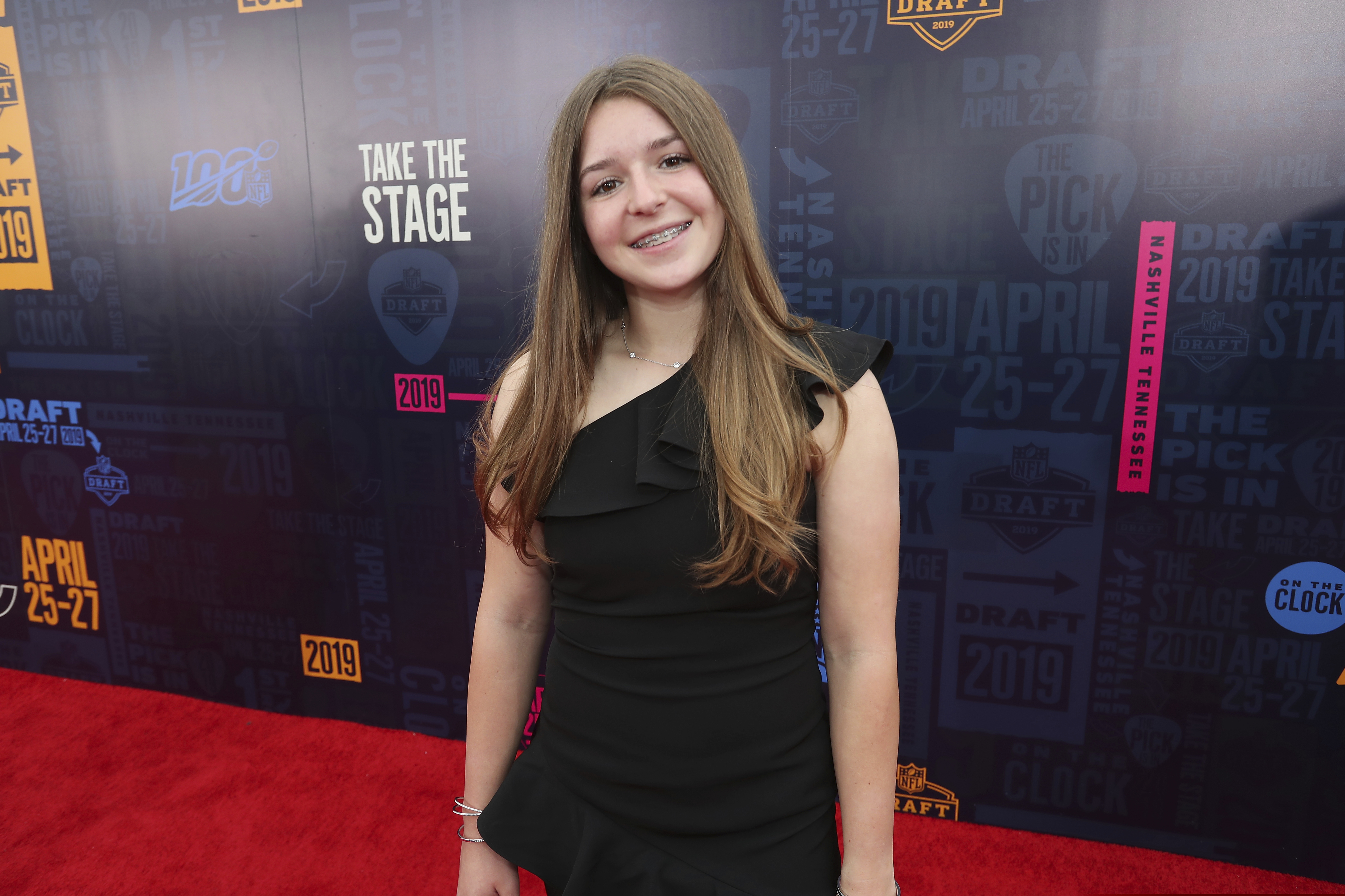 FILE - In this April 25, 2019, file photo, female football player Sam Gordon walks the NFL draft red carpet in Nashville, Tenn. Opening arguments in a lawsuit brought by Gordon pushing to compel the state to create all-girls football teams at high schools were heard in federal court Tuesday, Sept. 8, 2020. Gordon became an online star when a video of the then 9-year-old girl's dominant football skills against boys gained widespread attention online in 2012. She, her father and other girls who wanted to play football filed a lawsuit against the three districts and the Utah High School Activities Association five years later. (AP Photo/Doug Benc, File)
