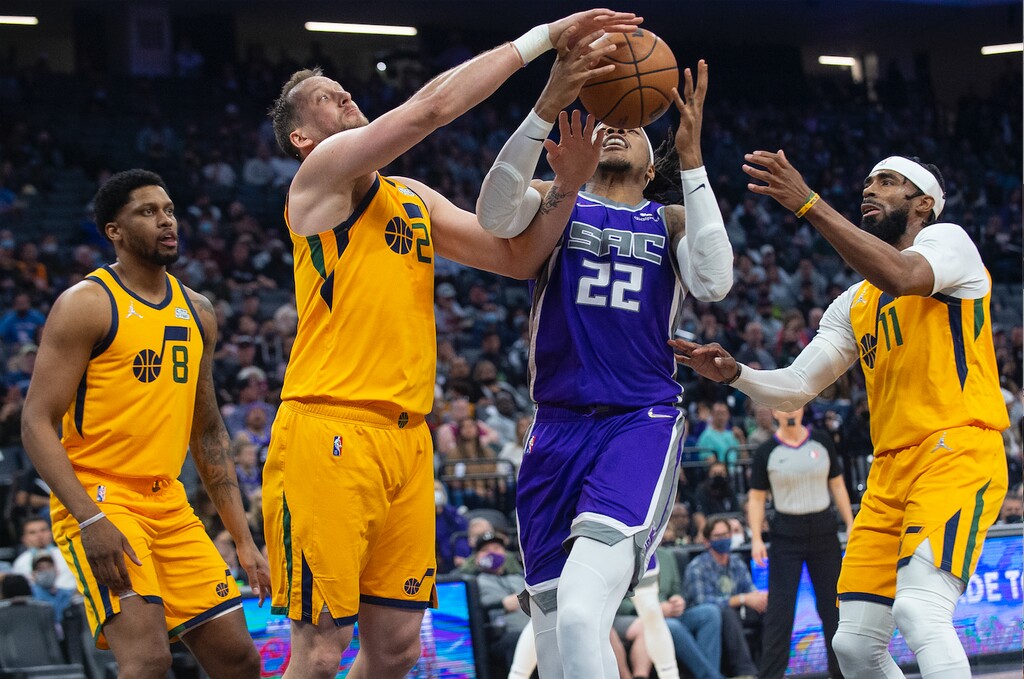 Utah Jazz forward Rudy Gay (8), guard Joe Ingles (2) and guard Mike Conley (11) guard against Sacramento Kings center Richaun Holmes (22) during the first quarter of an NBA basketball game in Sacramento, Calif., Saturday, Nov. 20, 2021. (AP Photo/Randall Benton)
