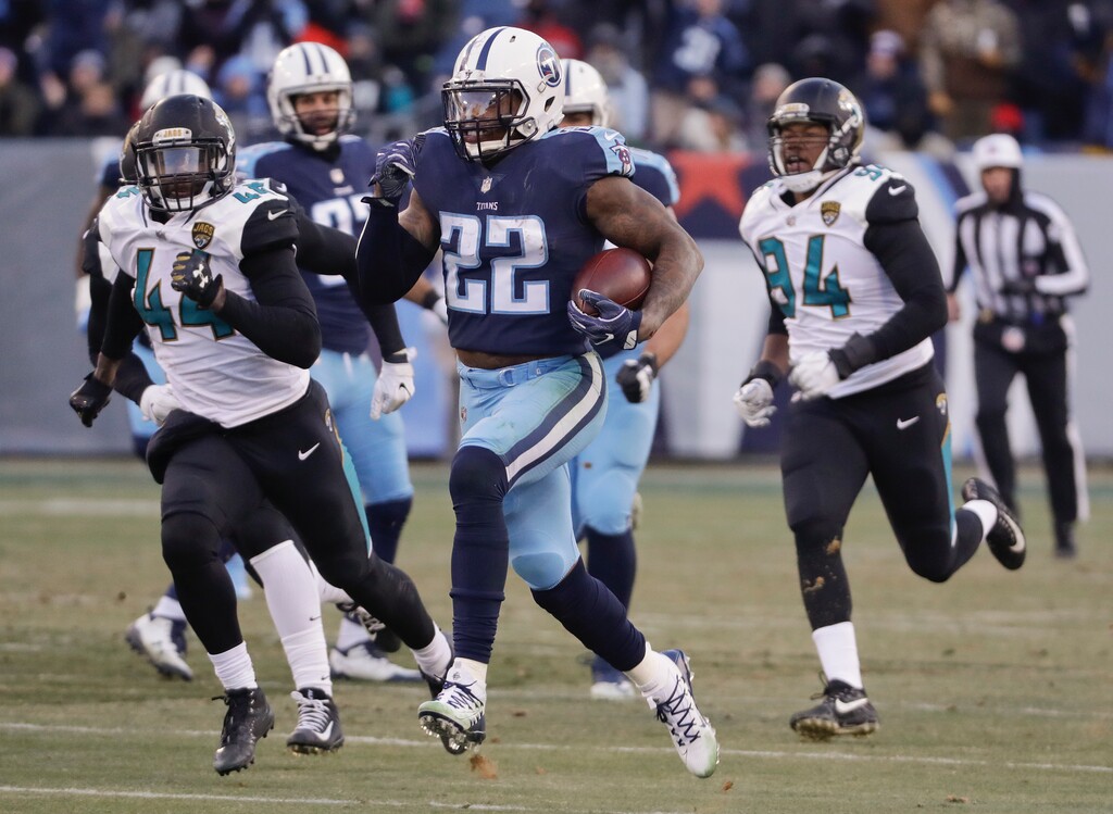 Tennessee Titans running back Derrick Henry (22) gets past Jacksonville Jaguars defenders Myles Jack (44) and Dawuane Smoot (94) as Henry scores a touchdown on a 66-yard pass play in the first half of an NFL football game Sunday, Dec. 31, 2017, in Nashville, Tenn. (AP Photo/James Kenney)