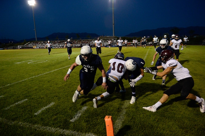 (Francisco Kjolseth  |  The Salt Lake Tribune)  Jordan quarterback Crew Wakley runs the ball into the end zone for a touchdown in the third quarter against Syracuse in game action at Syracuse on Thursday, Aug. 24, 2017.