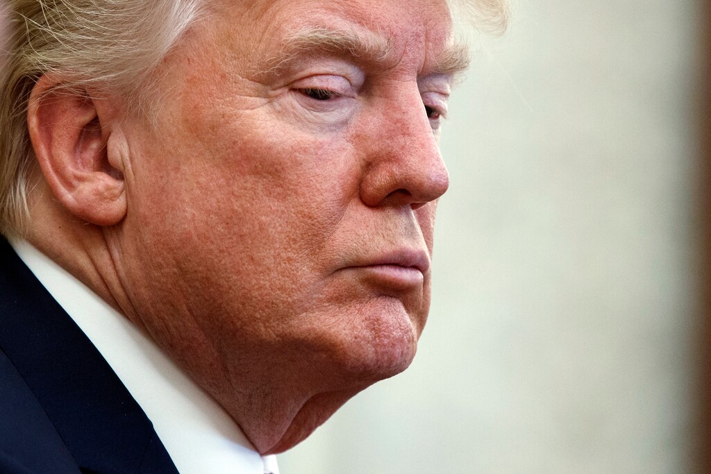 President Donald Trump listens during a meeting with North Korean defectors where he talked with reporters about allowing the release of a secret memo on the FBI's role in the Russia inquiry, in the Oval Office of the White House, Friday, Feb. 2, 2018, in Washington. (AP Photo/Evan Vucci)