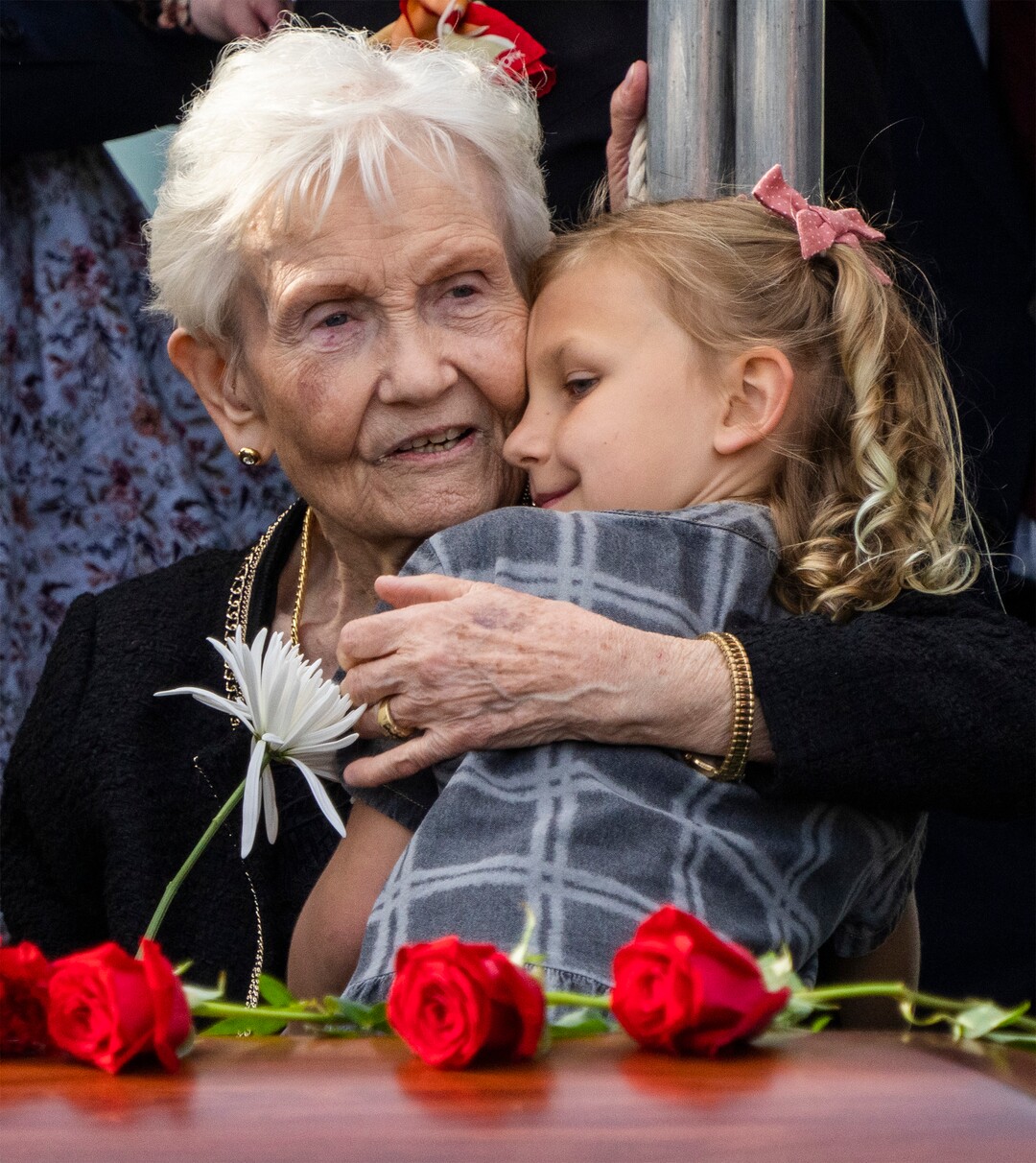 (Rick Egan | The Salt Lake Tribune)   Elaine Hatch, hugs her grand daughter, Scout Hoffman, 8, at the interment of her husband, Orrin Hatch at the Newton Cemetery, on Friday, May 6, 2022.