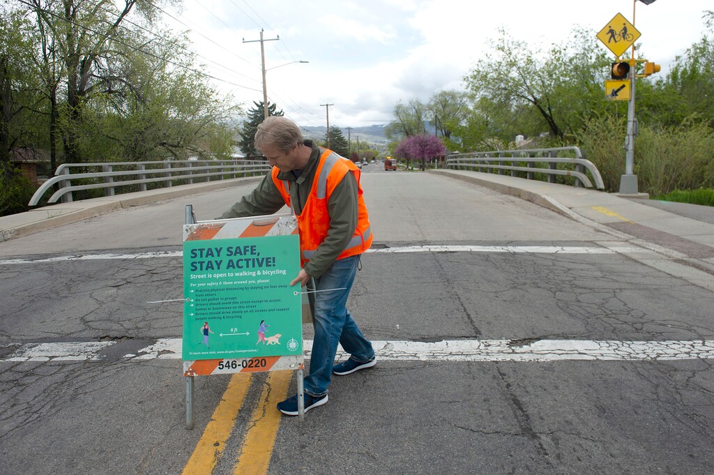 (Rick Egan | Tribune file photo) Dan Dergenthal sets up a sign on 500 North, April 23, 2020. Salt Lake City is temporarily closing some city streets to cars in an effort to promote social distancing. 500 North is the first street that has been designated.