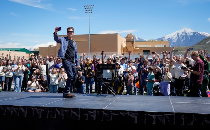 (Bethany Baker | The Salt Lake Tribune) Kevin Bacon records a video with the crowd, playing into the "six degrees from Kevin Bacon" game, following a charity event to commemorate the 40th anniversary of the movie "Footloose" on the football field of Payson High School in Payson on Saturday, April 20, 2024.
