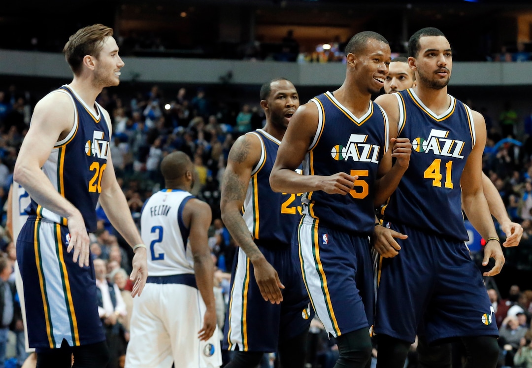 Utah Jazz's Gordon Hayward (20) , Rodney Hood (5), Trey Lyles (41) and Chris Johnson, rear, walk to the bench celebrating after Hood sank a 3-point basket late in the second half of an NBA basketball game against the Dallas Mavericks on Tuesday, Feb. 9, 2016, in Dallas. The shot tied up the game sending it into overtime where the Jazz won 121-119. (AP Photo/Tony Gutierrez)