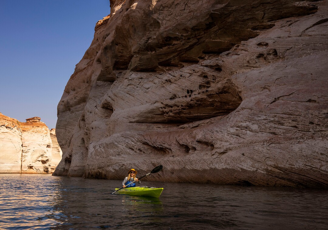 (Rick Egan | The Salt Lake Tribune)   River guide Jessie Pulliam, paddles a Kayak up Antelope Canyon, on Wednesday, Aug. 4, 2021. Water levels are dropping a few inches a day, which may bring an early end to kayaking in Glen Canyon in the next week or so, shortening a season that usually goes through the end of October. 
