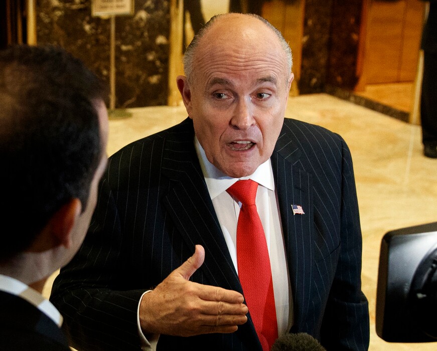 In this Jan. 12, 2017, file photo, former New York City Mayor Rudy Giuliani talks with reporters in the lobby of Trump Tower in New York. Giuliani's revelation that U.S. President Donald Trump reimbursed his personal attorney for a $130,000 payment to a porn star to keep her quiet about an alleged affair is raising new legal questions, including whether the president and his campaign violated campaign finance laws. Giuliani insisted on Fox News Channel Wednesday night, May 2, 2018, that the payment to adult film actress Stormy Daniels was "going to turn out to be perfectly legal." (AP Photo/Evan Vucci, File)