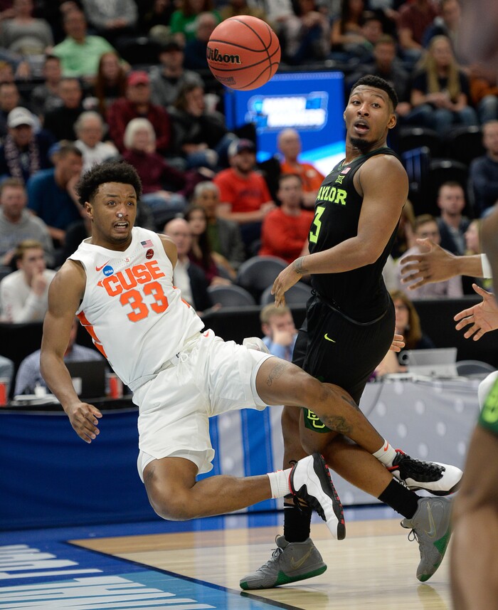 (Francisco Kjolseth  |  The Salt Lake Tribune)  Syracuse Orange forward Elijah Hughes (33) goes for a ride after pressure by Baylor Bears guard King McClure (3) as Syracuse faces Baylor in their first round menÕs NCAA March Madness tournament game at Vivint Smart Home Arena in Salt Lake City on Thursday, March 21, 2019.