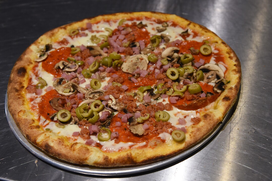(Francisco Kjolseth  |  The Salt Lake Tribune)  The Brooklyn pizza from Wicked Peel Pizza Kitchen in Riverton, with house tomato sauce, shredded mozzarella, pepperoni, sausage, ham, green olives, mushrooms and pecorino-romano cheese. 