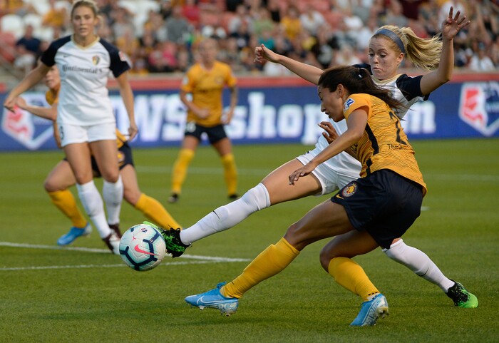 (Francisco Kjolseth  |  The Salt Lake Tribune)  North Carolina Courage midfielder Denise O'Sullivan (8) defends over Utah Royals FC forward Christen Press (23) as Utah Royals FC hosts the North Carolina Courage at Rio Tinto Stadium in Sandy, Utah on Saturday, July 27, 2019.