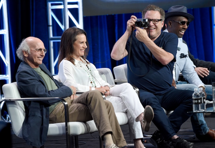 Actor/executive producer Jeff Garlin, second right, takes a photo as, from left, actor/creator/executive producer Larry David, Susie Essman and J.B. Smoove participate in the "Curb Your Enthusiasm" panel during the HBO Television Critics Association Summer Press Tour at the Beverly Hilton on Wednesday, July 26, 2017, in Beverly Hills, Calif. (Photo by Chris Pizzello/Invision/AP)