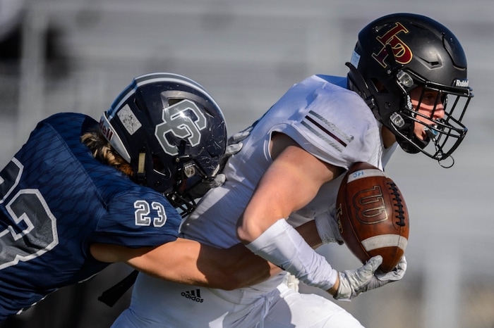 (Trent Nelson  |  The Salt Lake Tribune) Corner Canyon's Scott Iverson strips the ball from Lone Peak's Weston Covey as he nears the goal line during the 6A state football championship game at Cedar Valley High School in Eagle Mountain on Friday, Nov. 20, 2020.