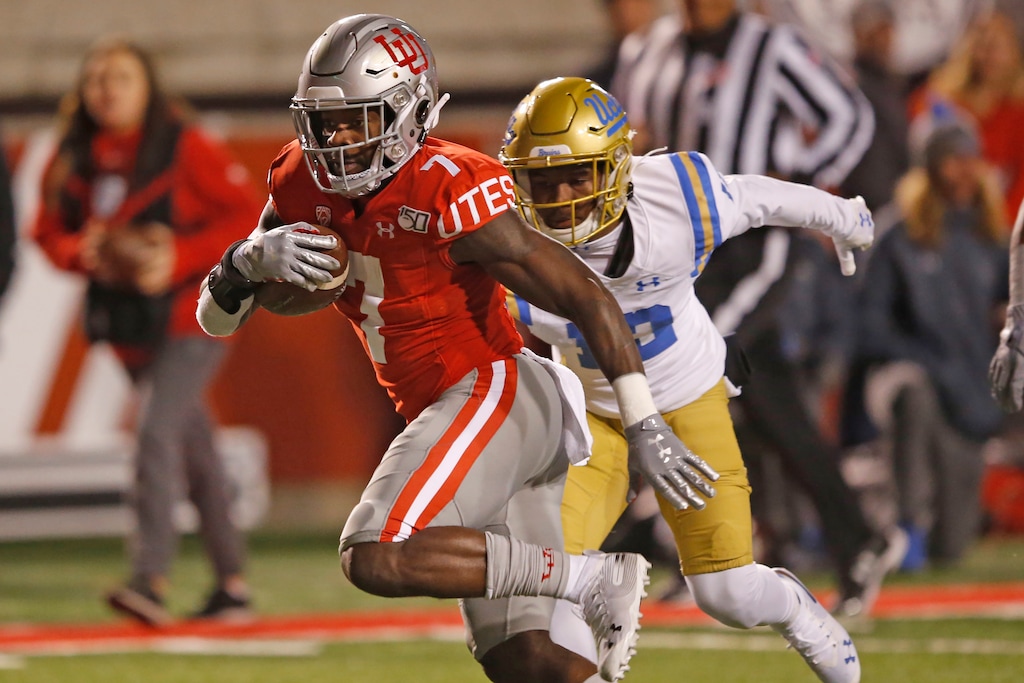 Utah running back Devonta'e Henry-Cole (7) outruns UCLA defensive back Elijah Gates, rear, in the second half during an NCAA college football game Saturday, Nov. 16, 2019, in Salt Lake City. (AP Photo/Rick Bowmer)