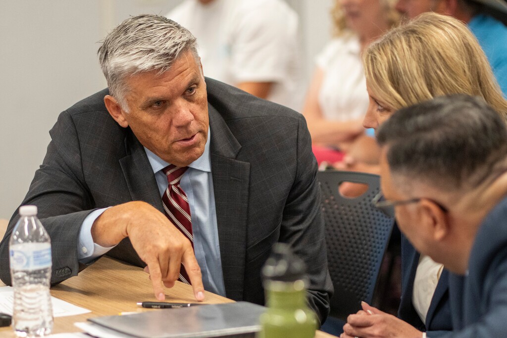 (Rick Egan | The Salt Lake Tribune)  Phil Lyman has a chat with Michael Clara at the Utah State Records Committee on Thursday, July 18, 2024. Lyman has lost his legal bid to remove Gov. Spencer Cox from office and the fall ballot.