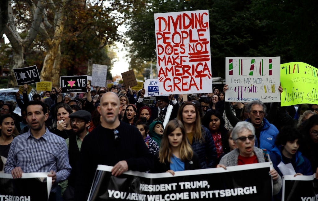 (Matt Rourke | The Associated Press) Protesters demonstrate near Pittsburgh's Tree of Life Synagogue where President Donald Trump and first lady Melania Trump were visiting a memorial in Pittsburgh, Tuesday, Oct. 30, 2018. The Trumps came to Pittsburgh to honor the victims of a mass shooting at the synagogue last week.