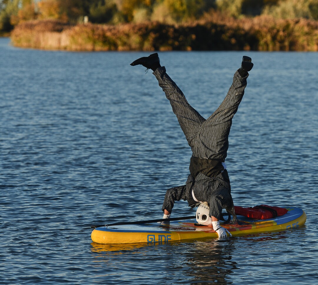 (Francisco Kjolseth  |  The Salt Lake Tribune)  Stand up paddle board enthusiast Chris Knoles takes to the water at Bountiful Pond on Tuesday, Oct. 30, 2018, in what has become a Halloween tradition for the 4th year in a row as they dress up this year as Jack and Sally Skellington from the movie Nightmare Before Christmas. "We paddle year round but actually paddle more in the winter," exclaimed Knoles, who carry the tradition on at Christmas, dressing up in something festive and paddling on the Great Salt Lake where the high salinity usually keeps the water from freezing.