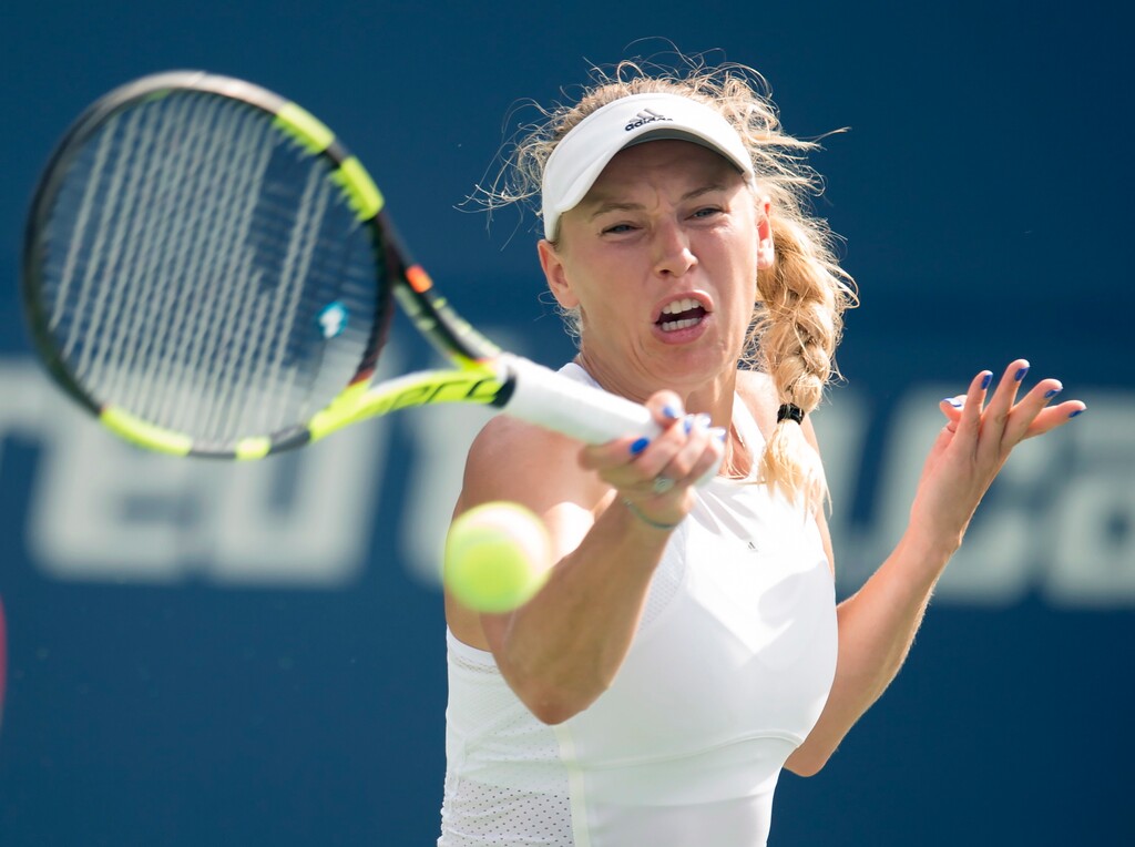 Caroline Wozniacki, of Denmark, hits a forehand to Karolina Pliskova, of the Czech Republic, during a Rogers Cup quarterfinal tennis match in Toronto, Friday Aug. 11, 2017. (Frank Gunn/The Canadian Press via AP)